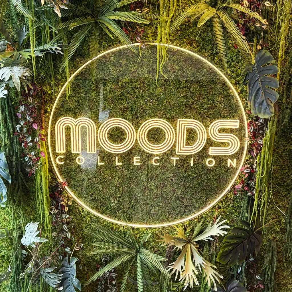 Rond LED neon logo op maat in interieur met groene wand